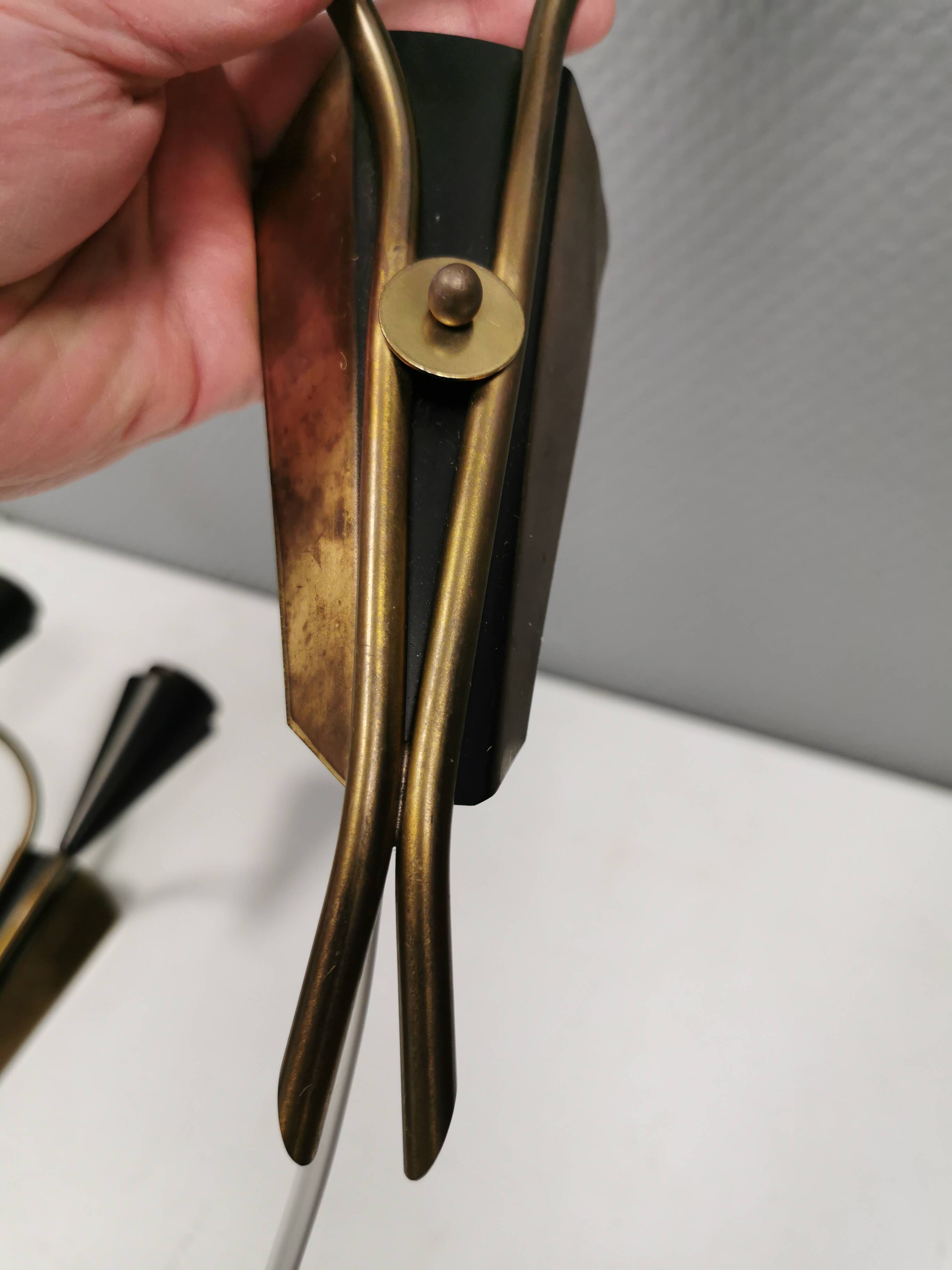 A set of wall lamps in black lacquered metal with brass details