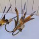 Brass wall lights with a bouquet of reeds by FlorArt.