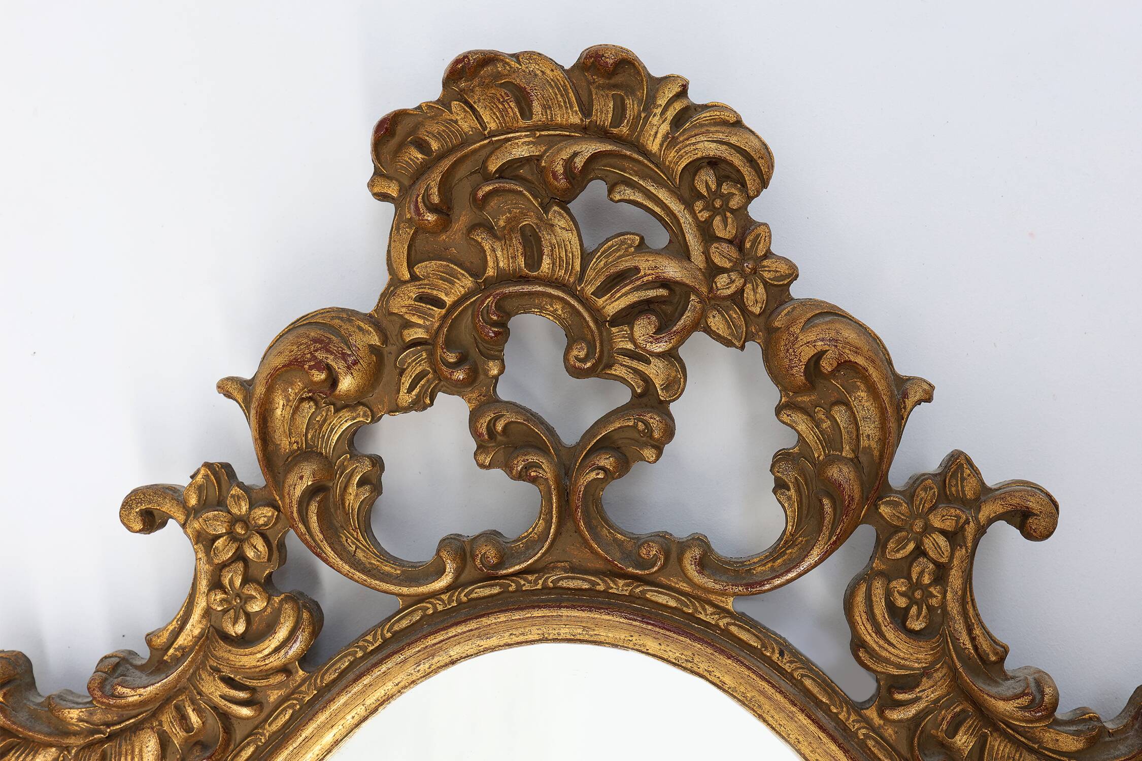Baroque style oval wall mirror in gilded wood, France