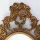Baroque style oval wall mirror in gilded wood, France