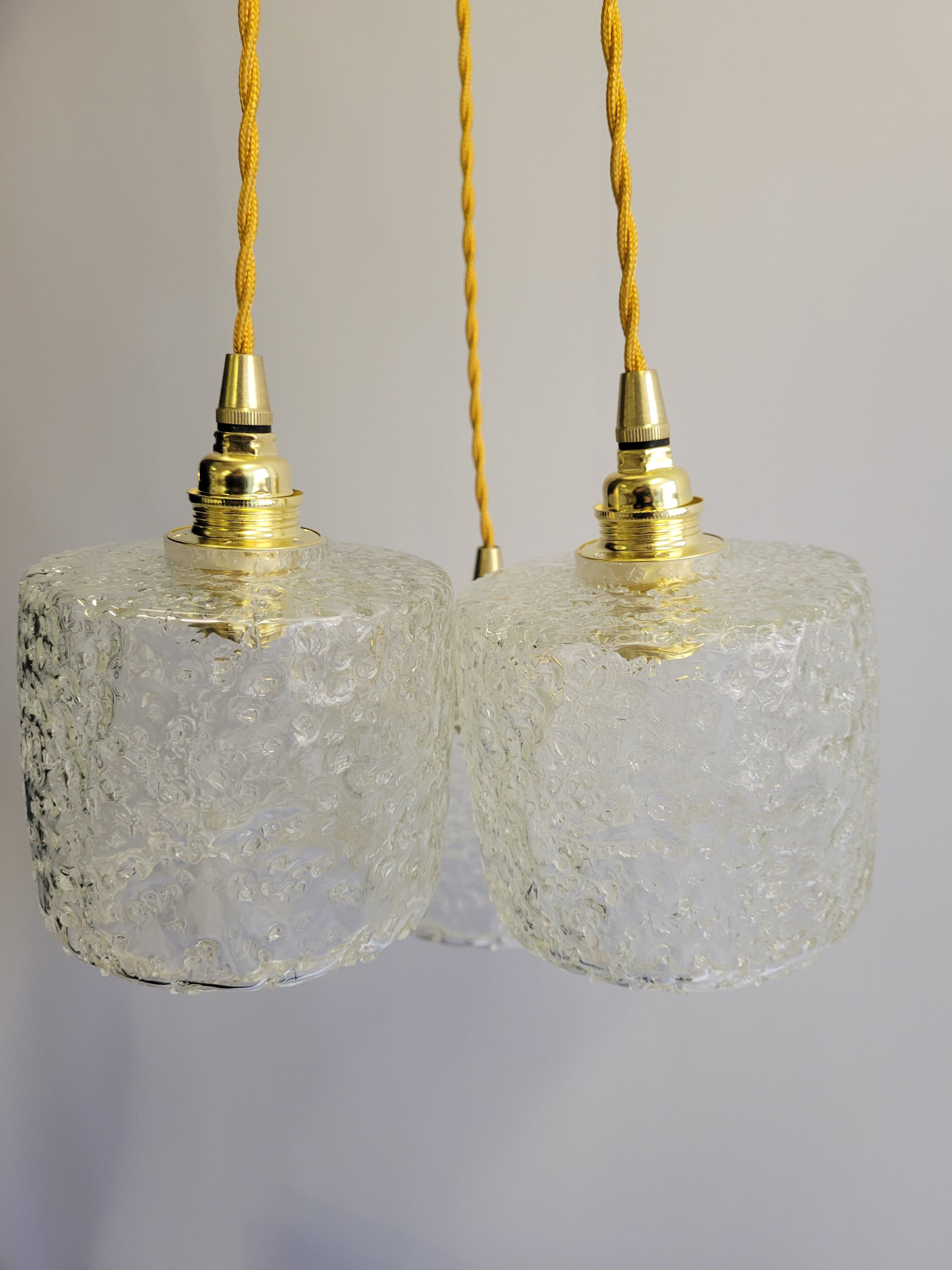 Trio of scrambled glass pendant lamps