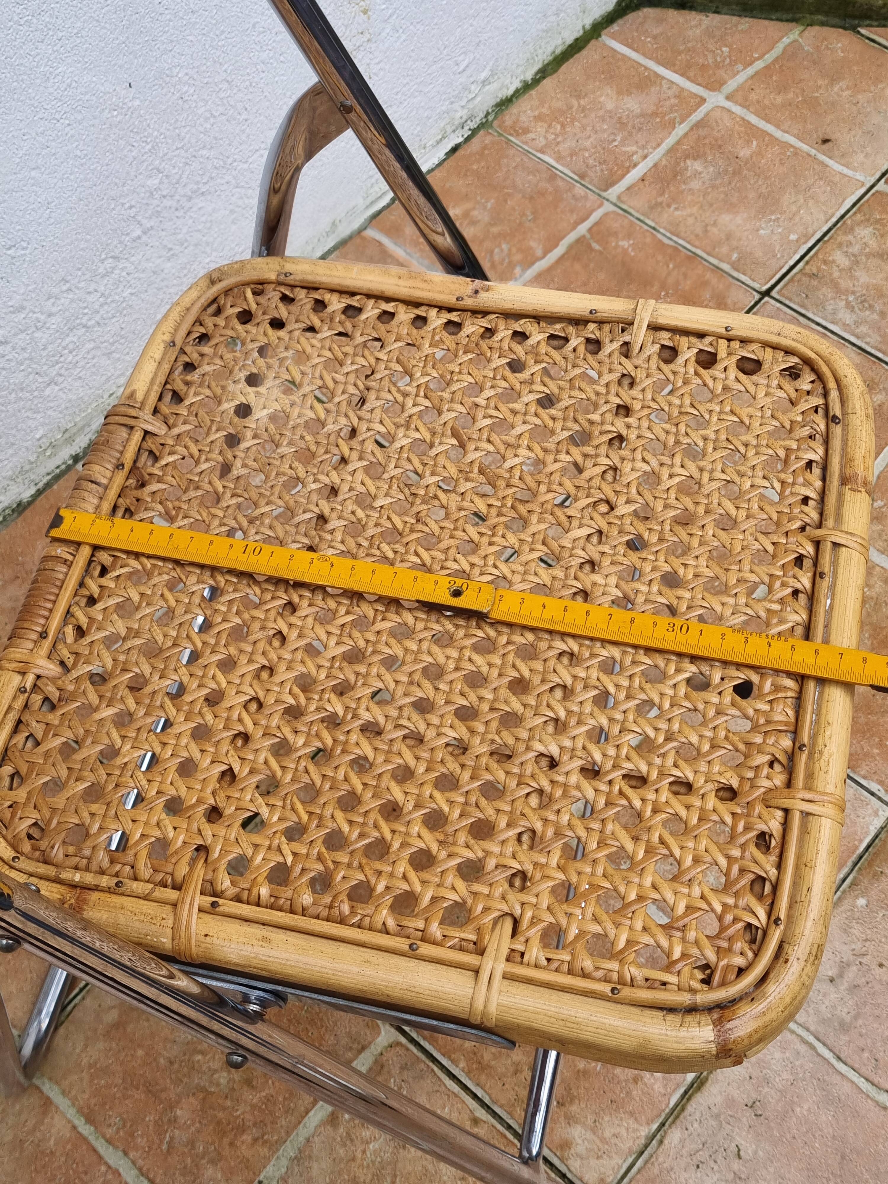 Pair of vintage metal and cane folding chairs