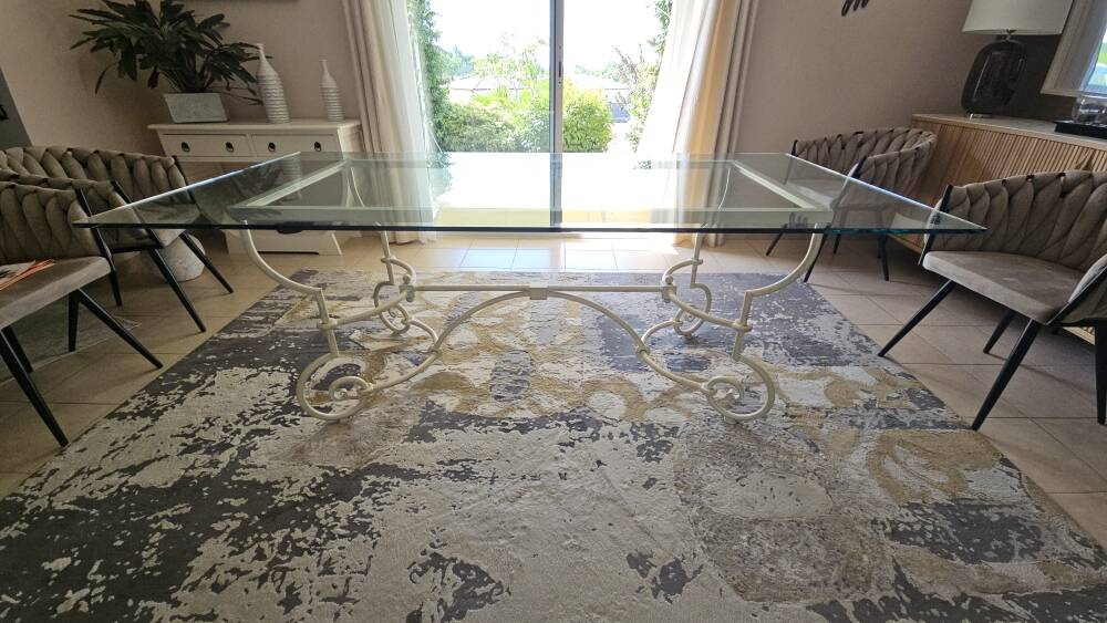 Wrought iron table by Roche Bobois, with a glass top.