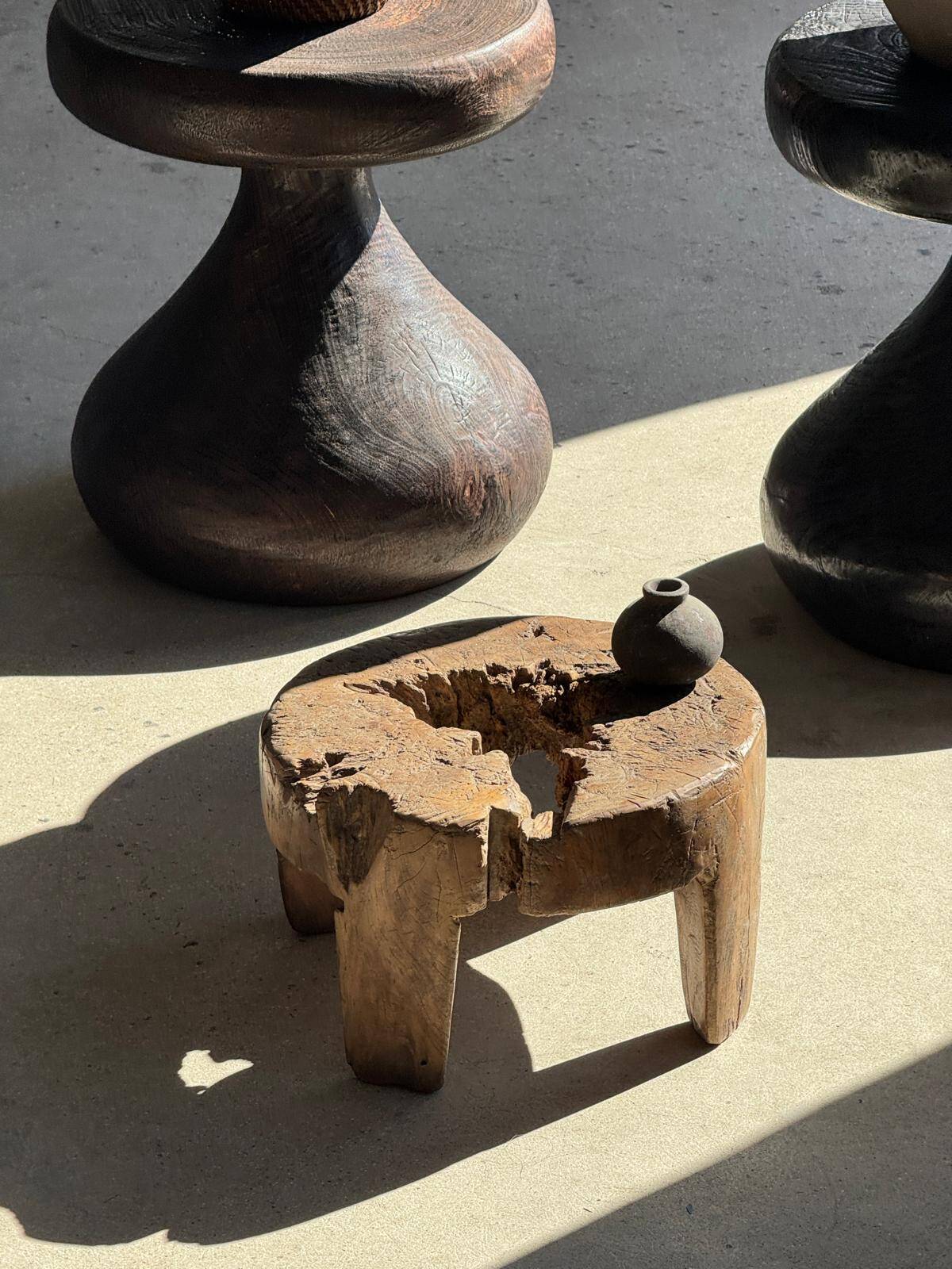 Small low circular four-legged stool in organic old teak with cut-out design H2