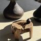 Small low circular four-legged stool in organic old teak with cut-out design H2