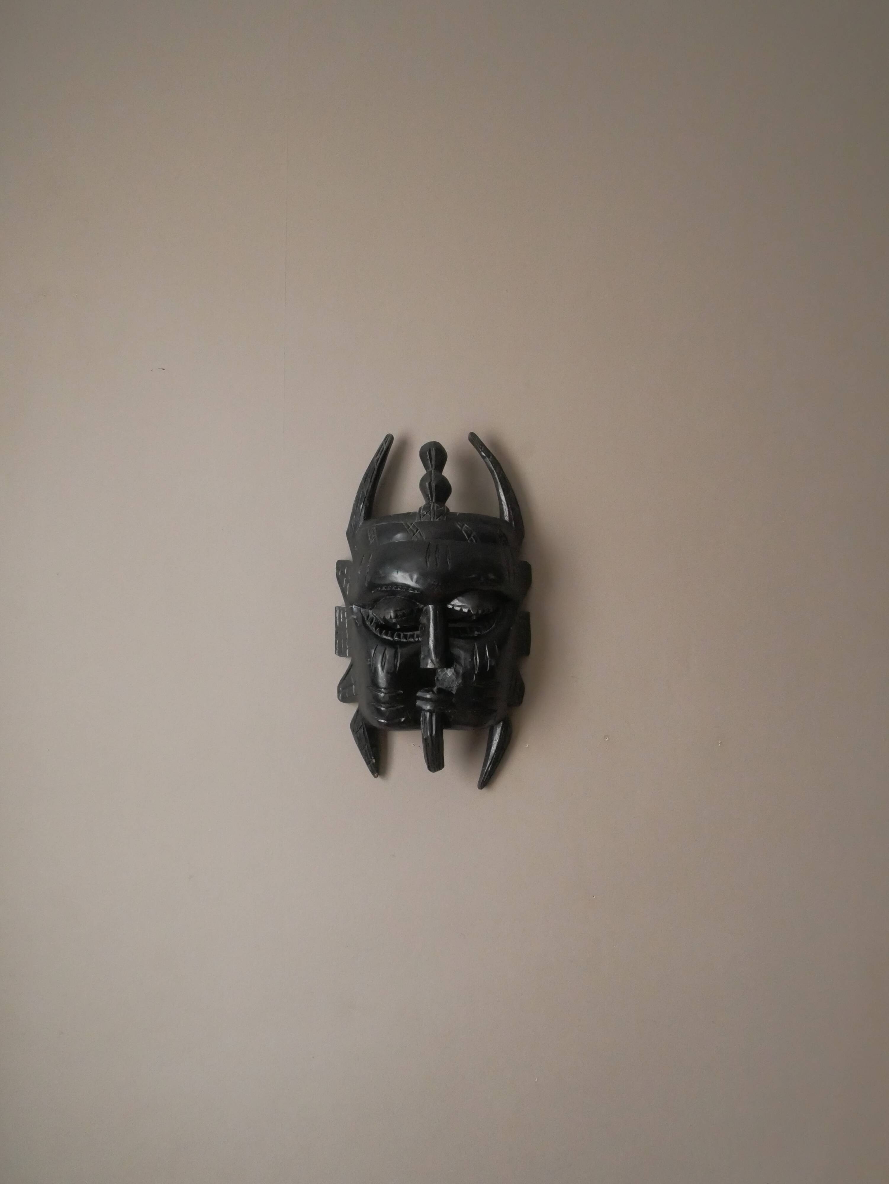 Decorative mask hand carved in tribal ethnic painted wood