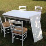 White farmhouse table set and four chairs