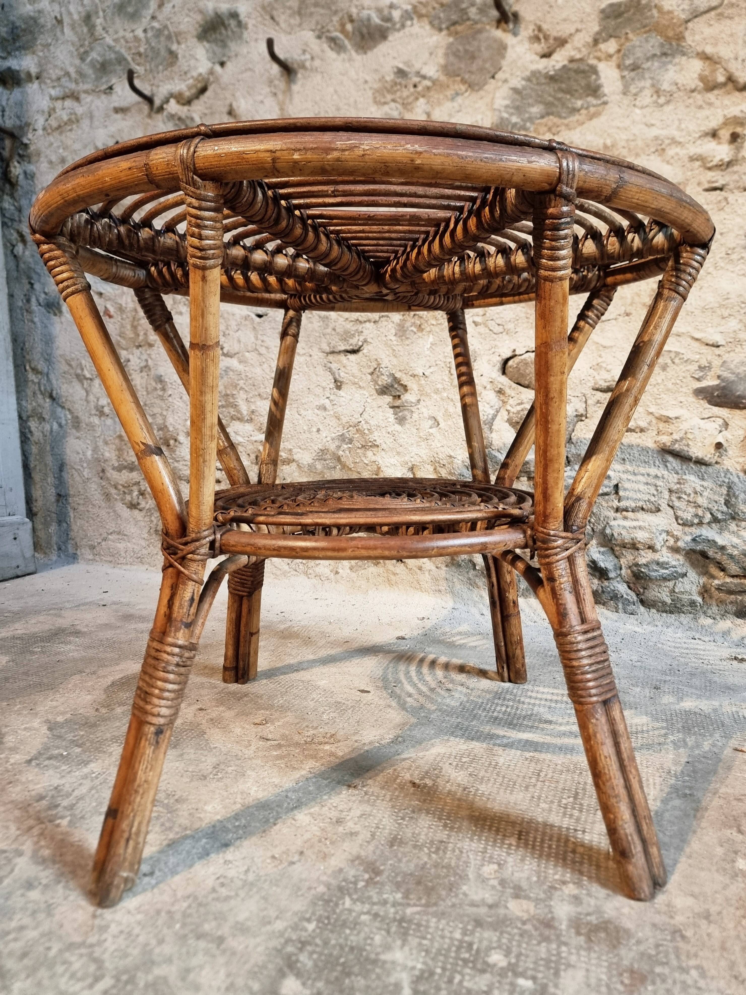 Vintage rattan lounge set, French wicker armchairs and round table, circa 1930–1950.