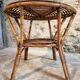 Vintage rattan lounge set, French wicker armchairs and round table, circa 1930–1950.