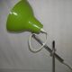 Green desk lamp with an arm from the 1970s.