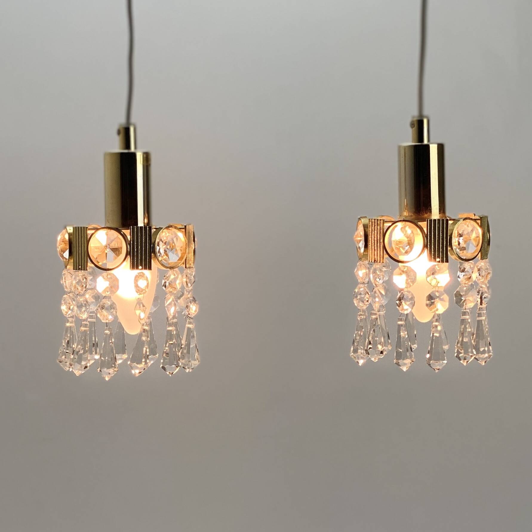 Two gold-plated brass and crystal pendant lights, by Palwa, 1960s design, Hollywood Regency.