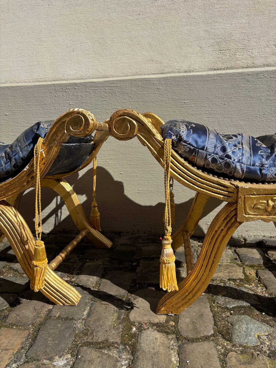 2 wooden footrests with blue cushions