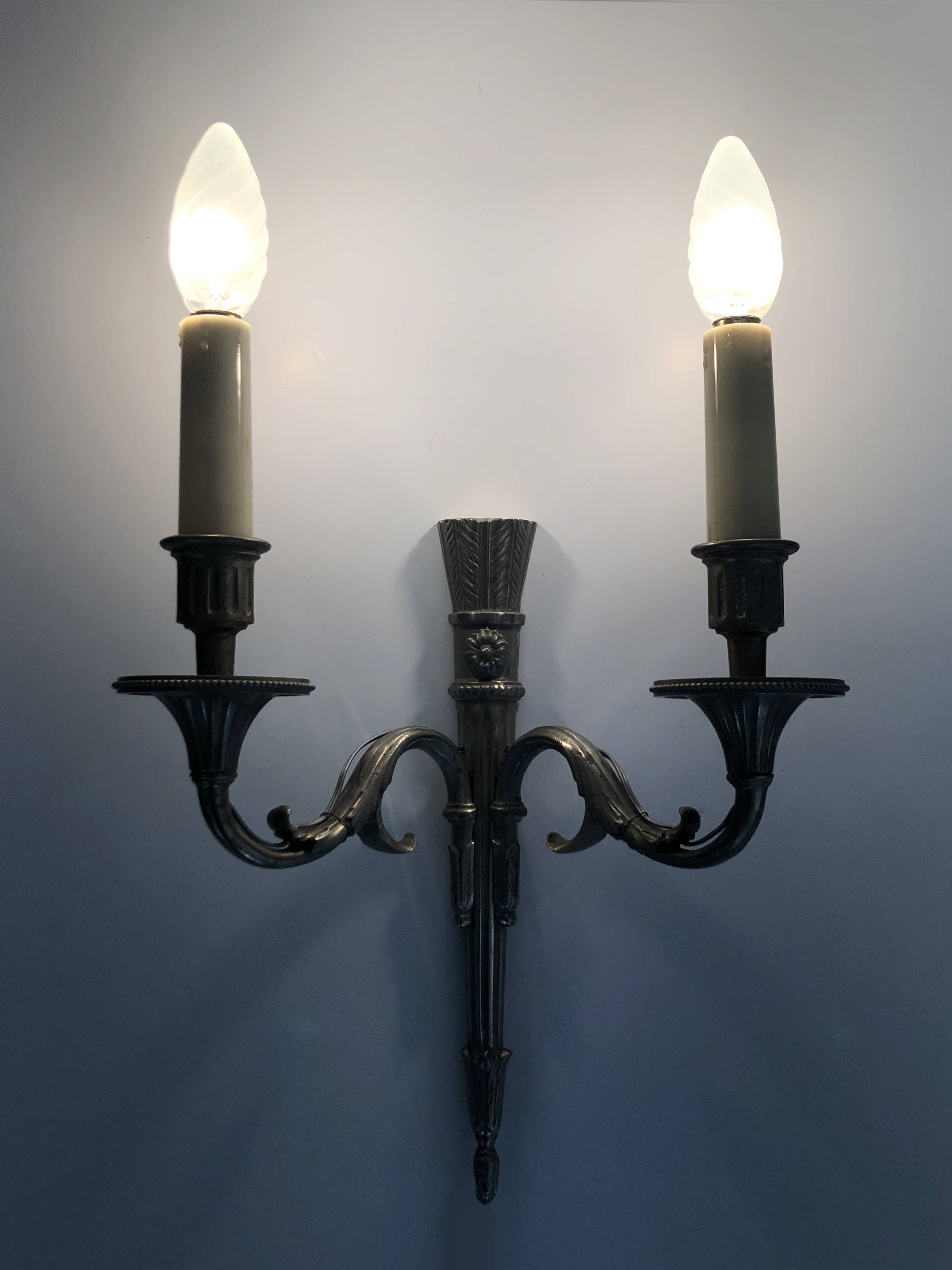 Pair of empire style double light wall lights in silvered bronze. the 50's