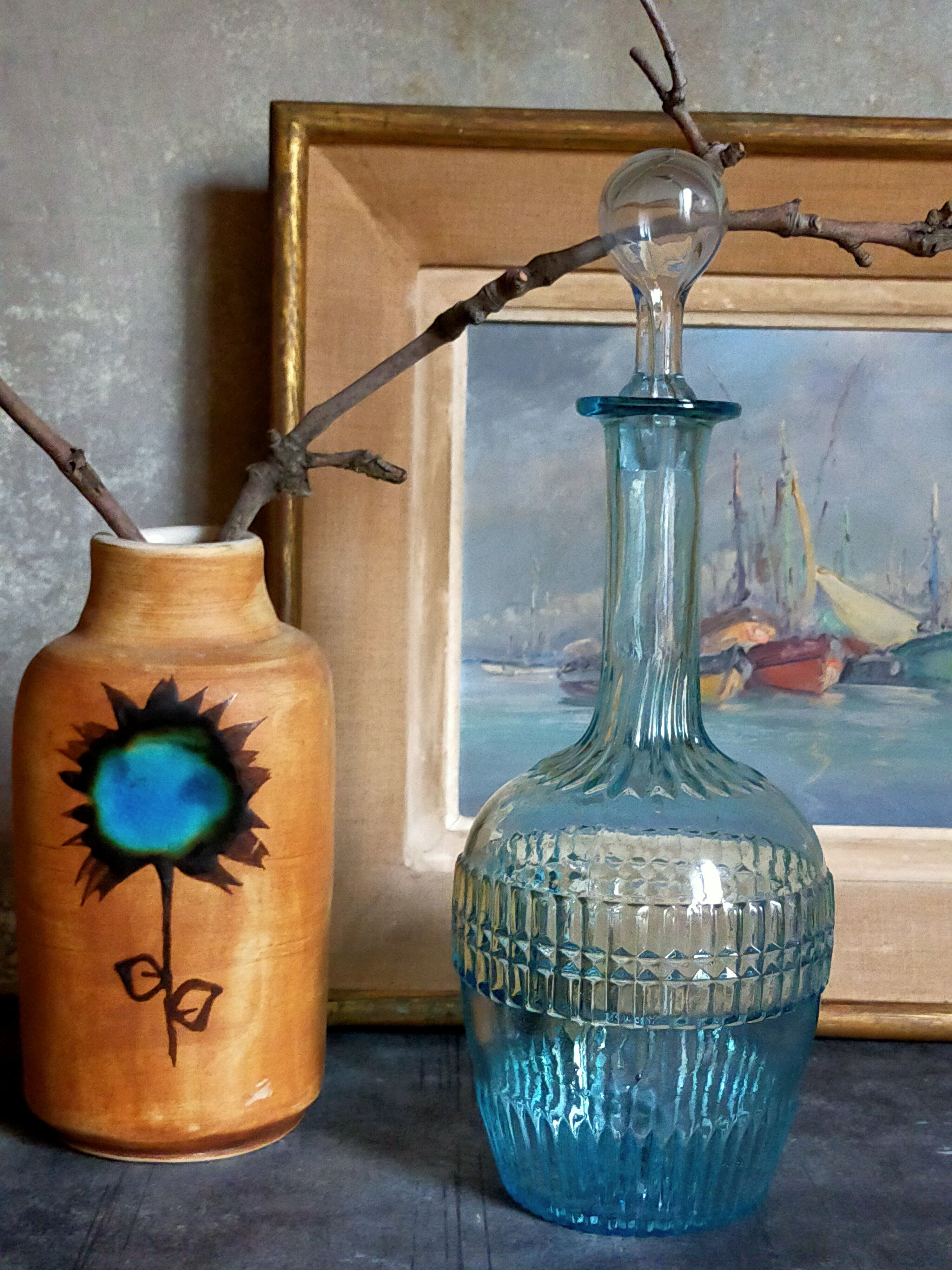 Blue glass carafe with vintage pegs