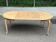 Large round/oval dining table in a chic country style, made of stripped oak with an extension.