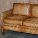 Three-seater leather canapé in Edwardian style with studs.
