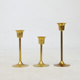 A set of three golden candlesticks, 1970s