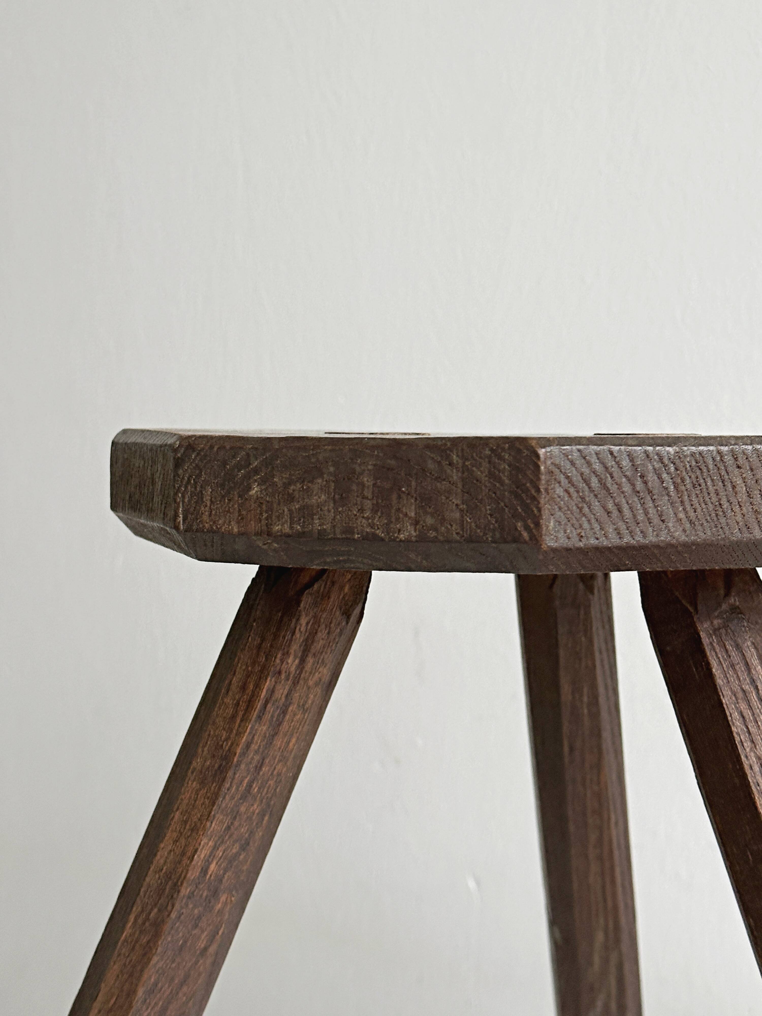Small dark wooden tripod stool