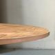 Mid-century round tulip dining table with a wooden top, vintage 1970s design.