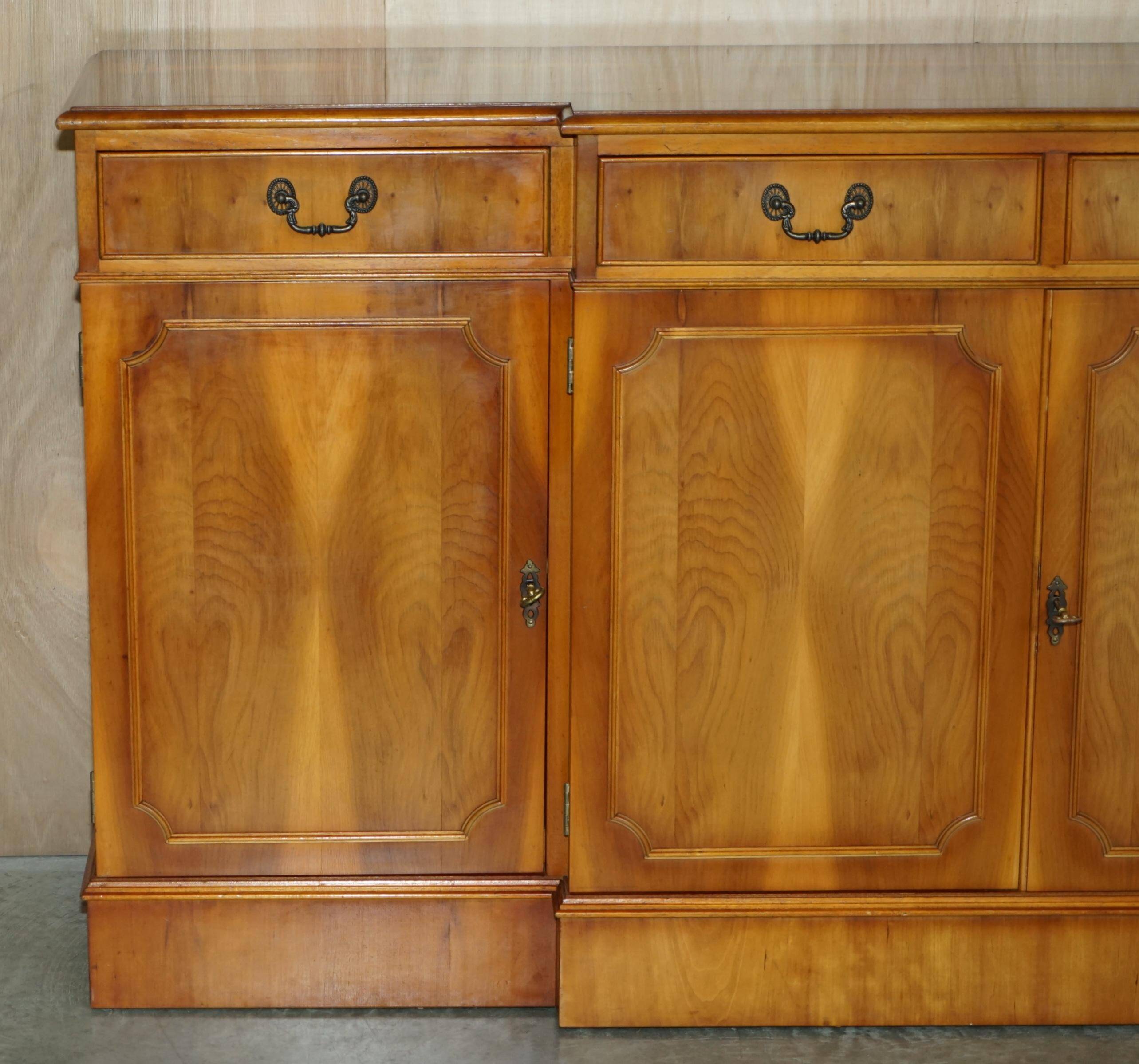 Vintage buffet made of mottled yew wood with three doors and four drawers.