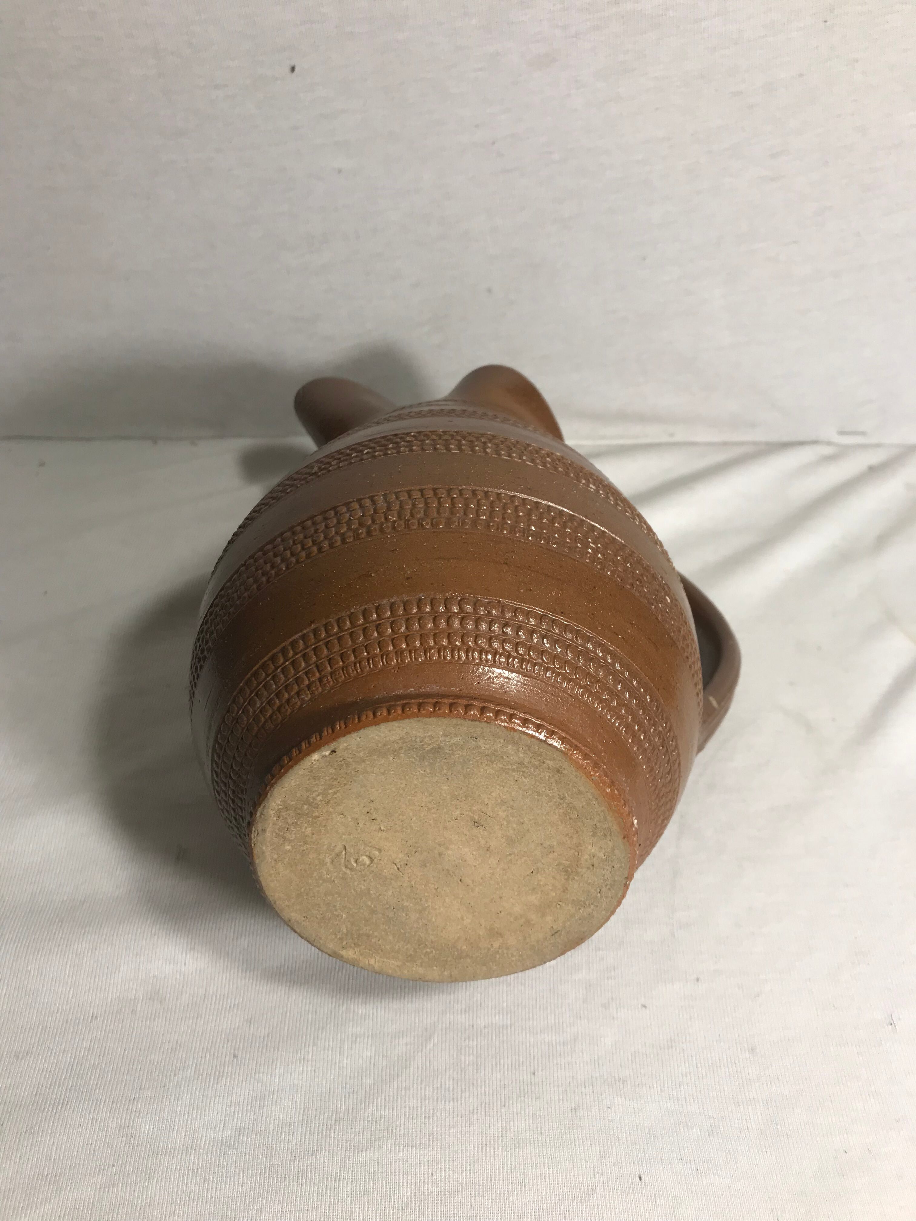 Old brown glazed ceramic jug from the 1950s