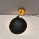 A wall lamp in black and brass-coloured finishes. Danish, early 2000s.