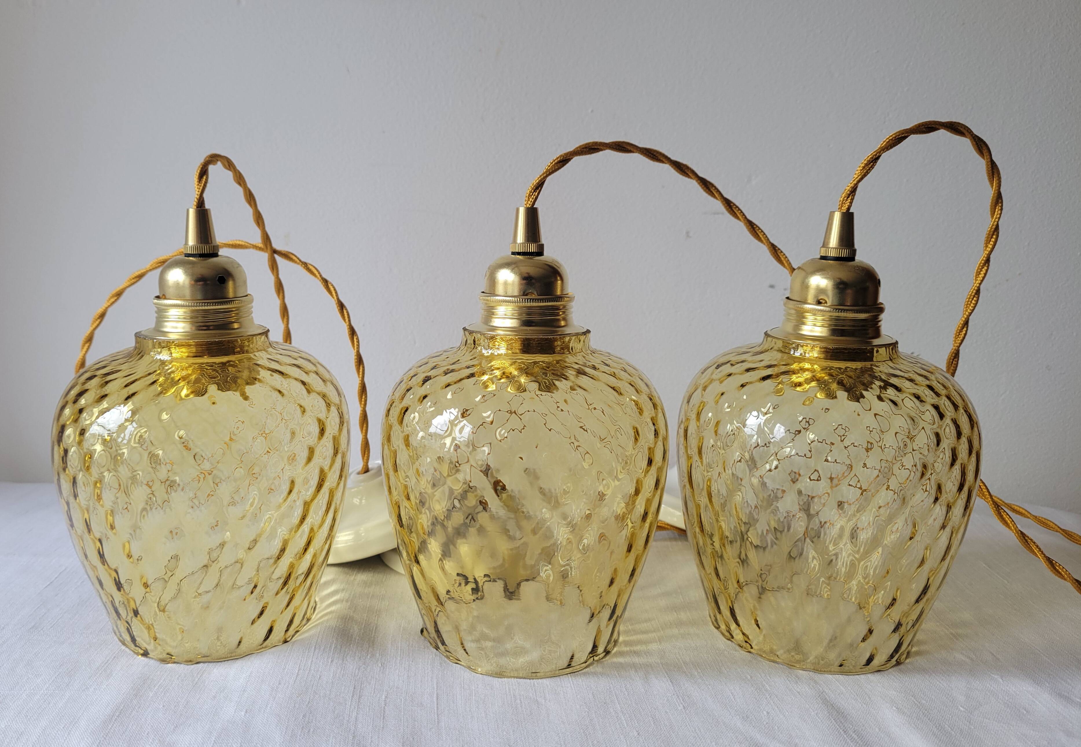 Trio of yellow glass pendant lights