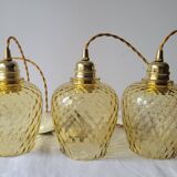 Trio of yellow glass pendant lights