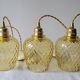 Trio of yellow glass pendant lights