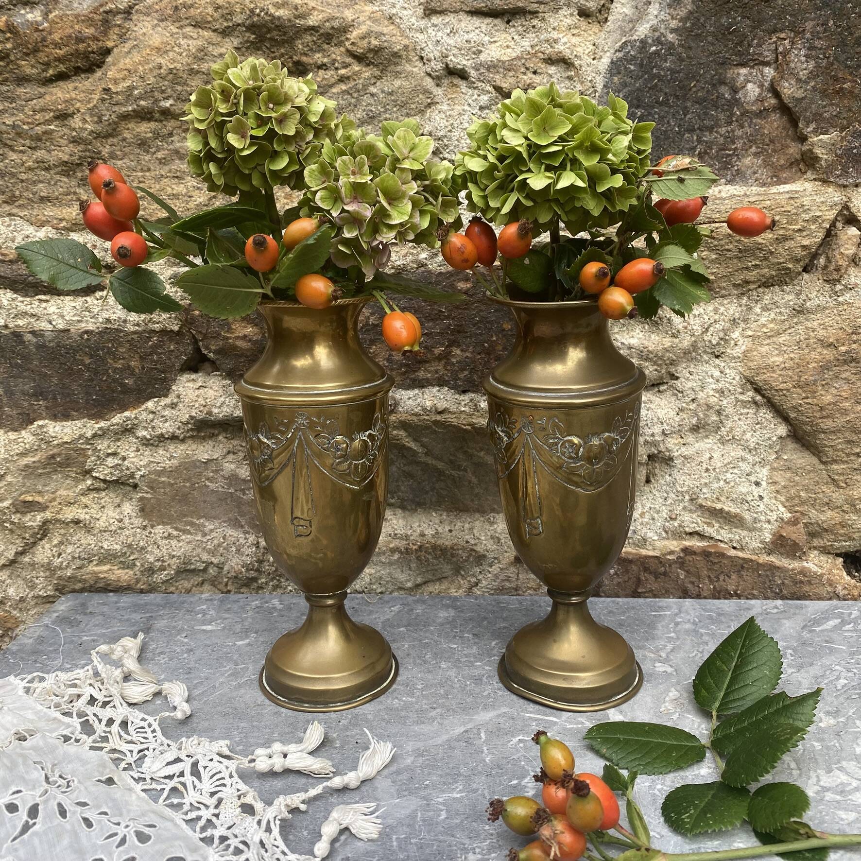 Pair of embossed brass bud vases stamped 17 cm