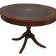 English style round table with green and gold leather top, quadripod with brass claws
