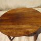 Walnut drop-leaf table with honey spoon legs.