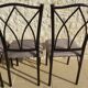 4 black metal chairs with high backs and gray suede tops