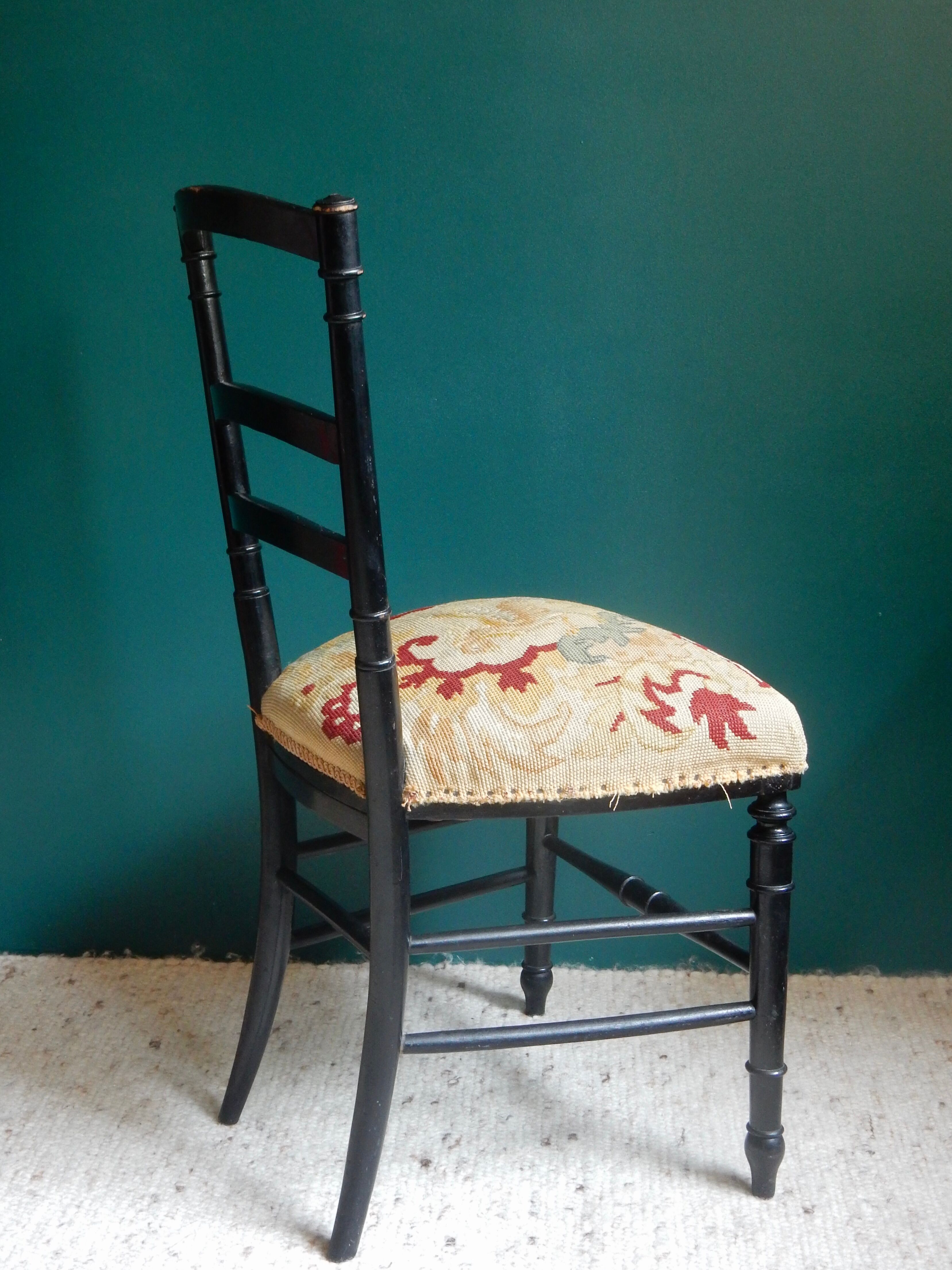 Black Napoleon III chair lined with phoenix