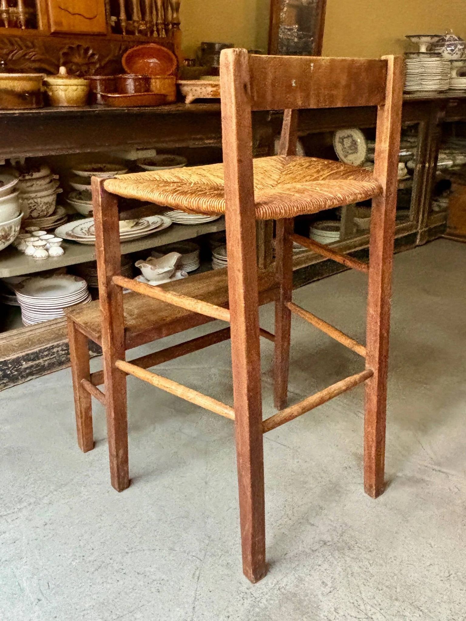 High chair made of wood and straw.