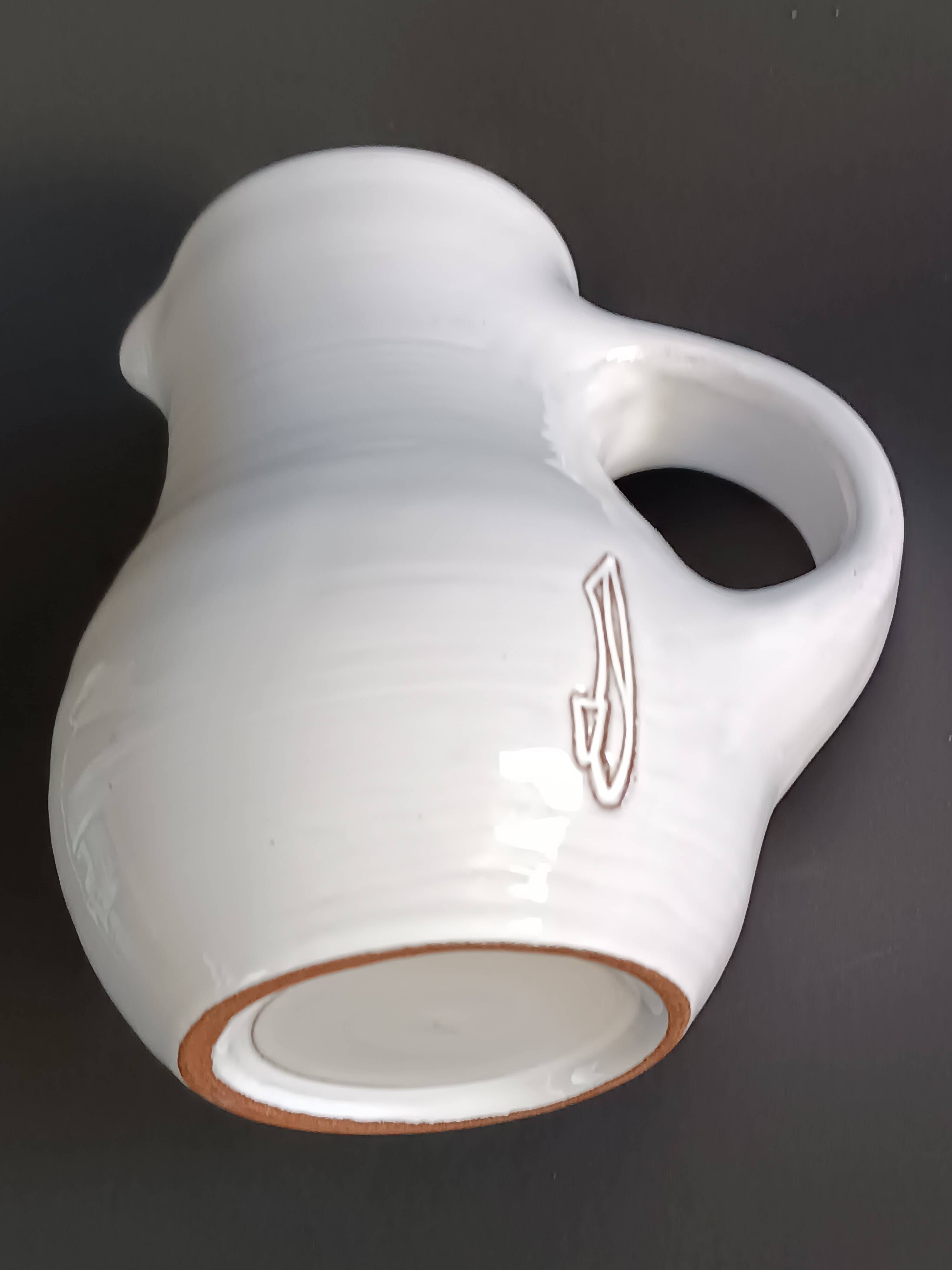 Vintage white glazed ceramic pitcher signed