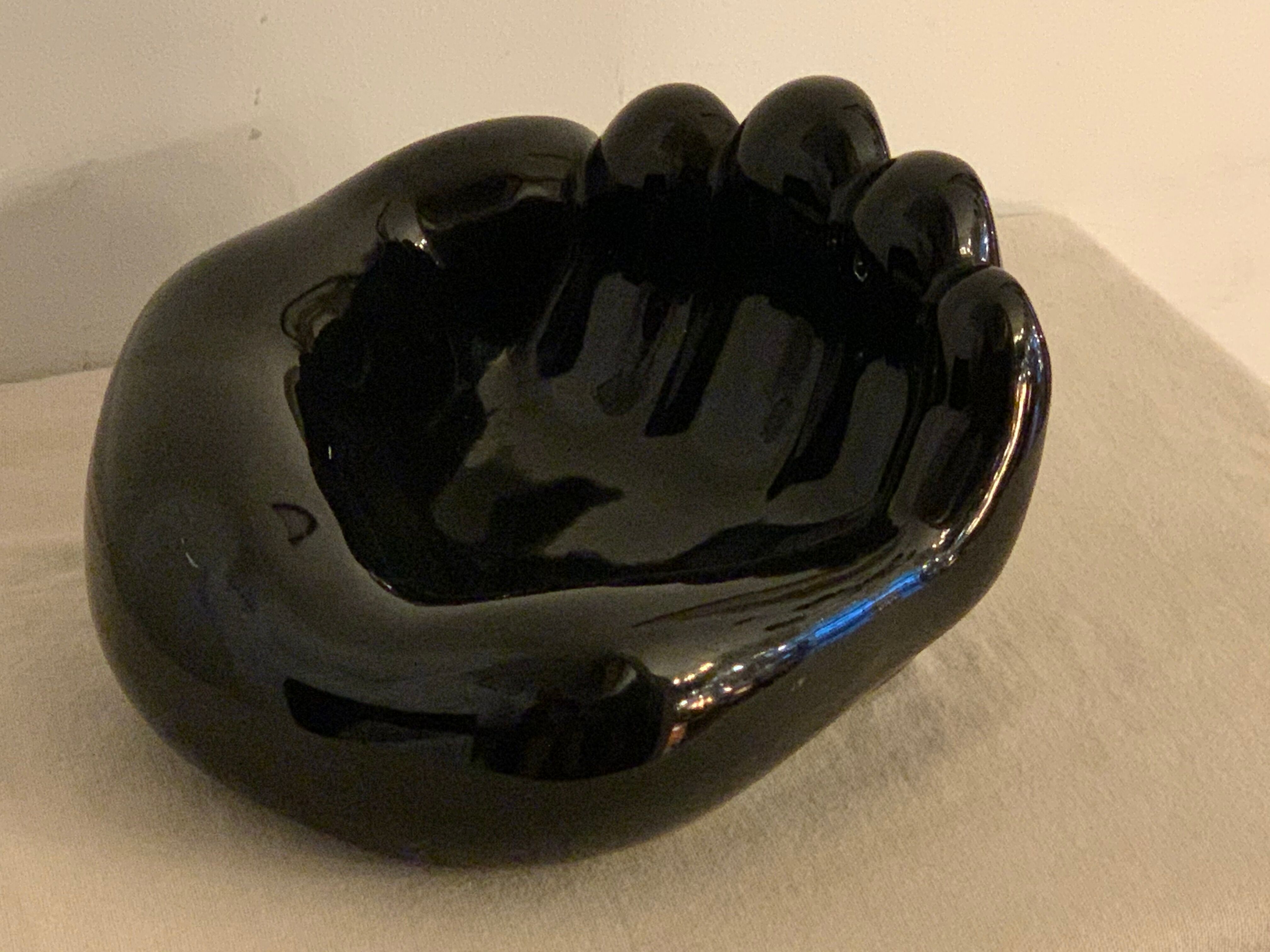 Black ceramic ashtray left hand