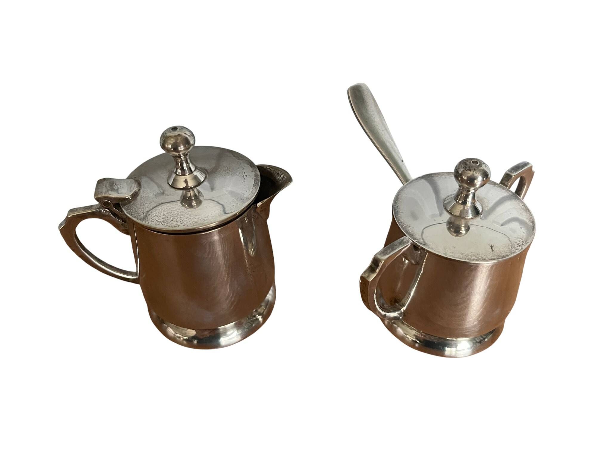 Two small silver-plated metal tea service pots from the 20th century.