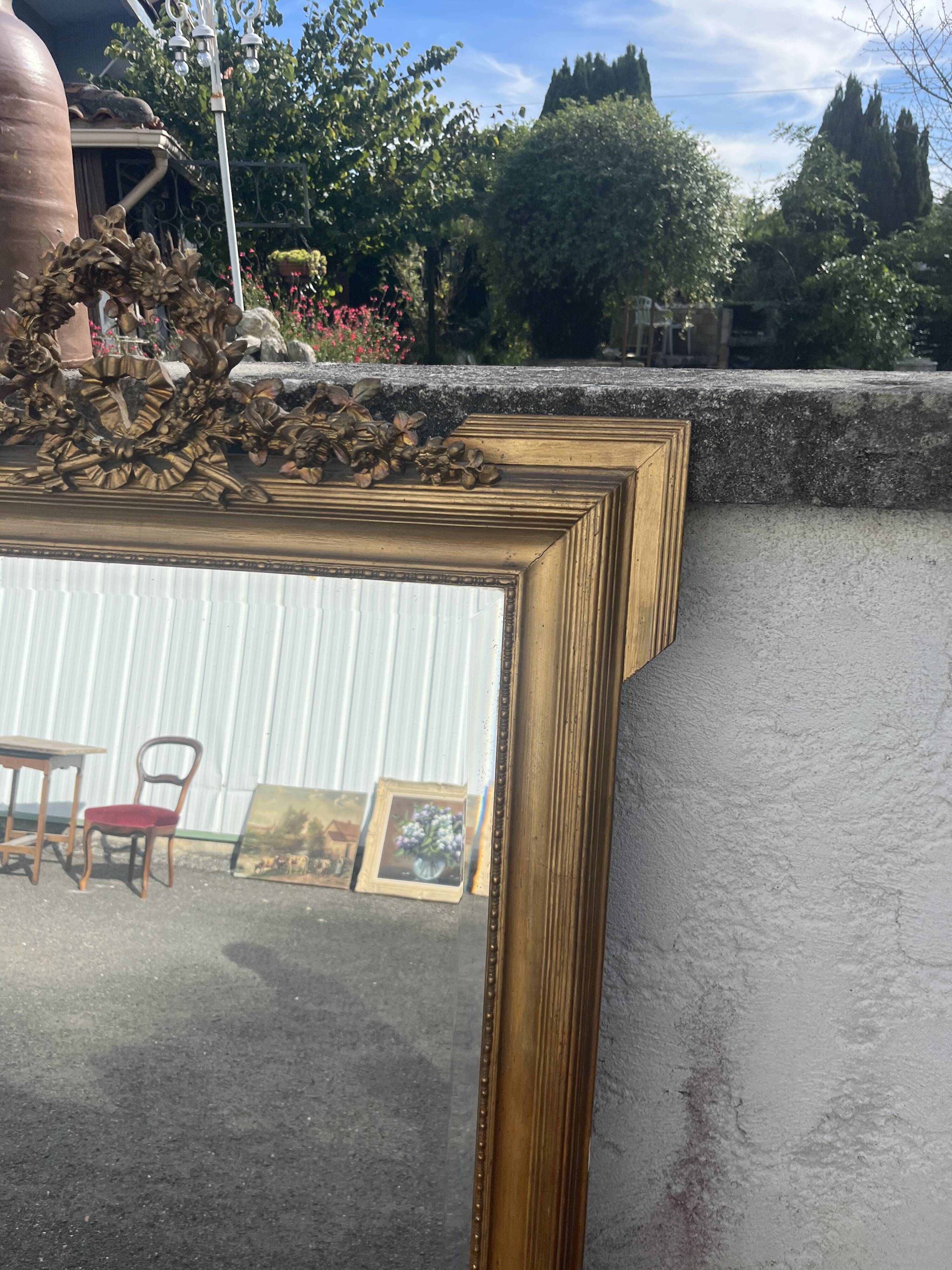 Large antique gilded mirror with carved pediment, 126 cm