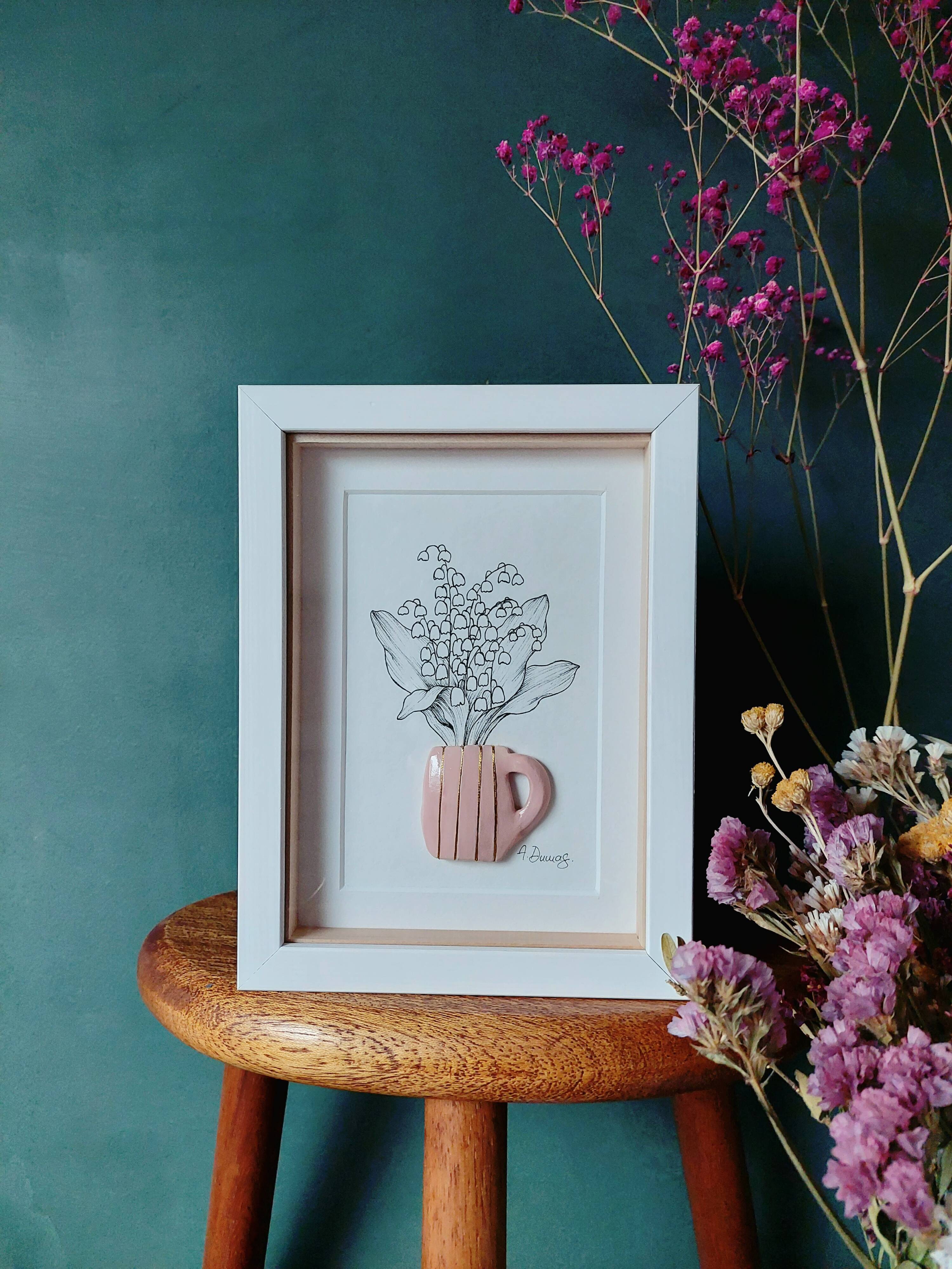 Composition of a bouquet of lily of the valley in a clay mug