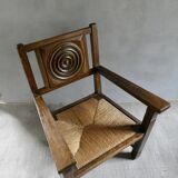 Armchair in carved solid wood with straw seat