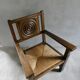 Armchair in carved solid wood with straw seat