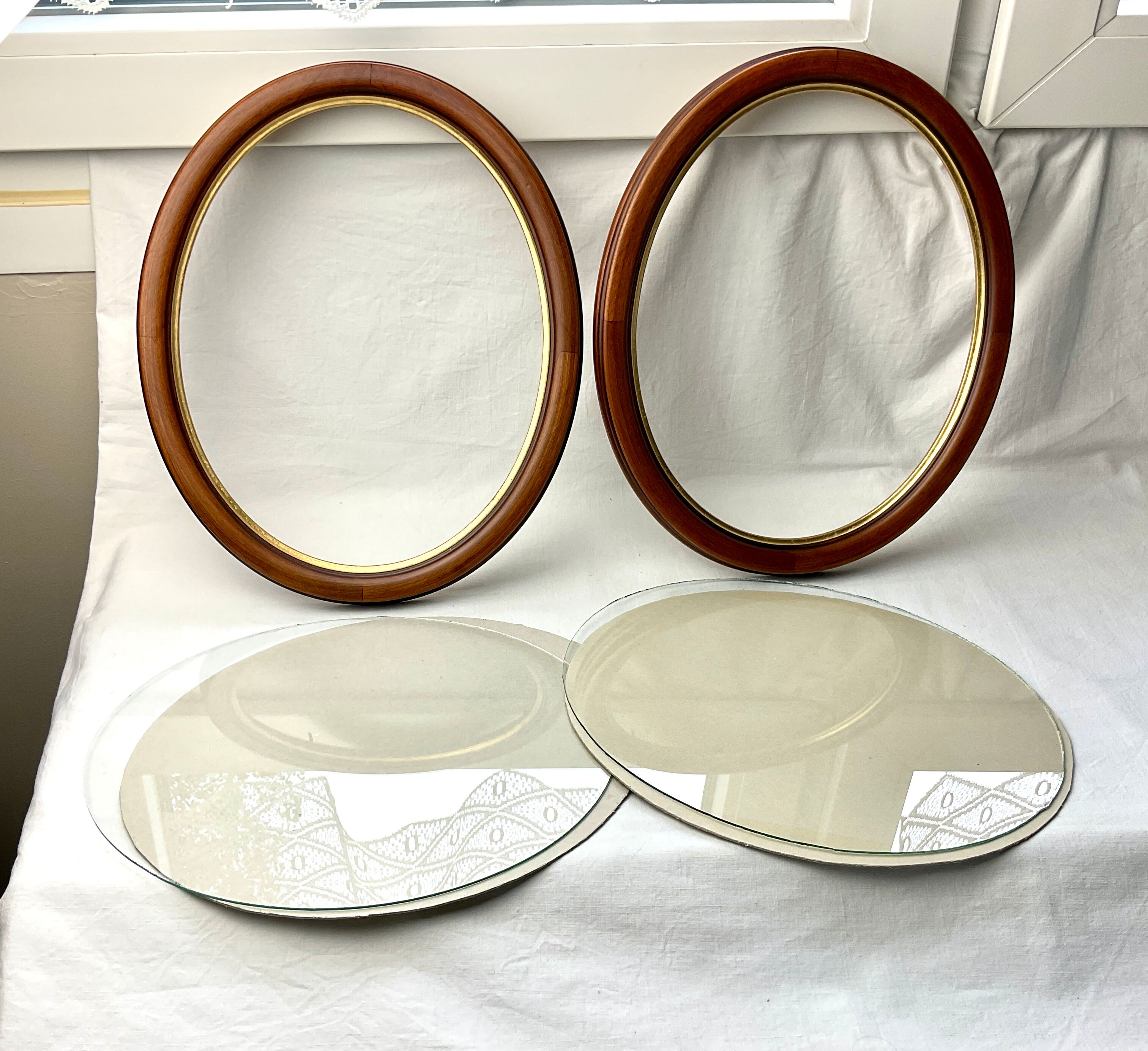 Pair of oval wooden frames with gilding