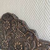 Ancient oriental mirror in embossed copper