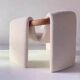 Sculptural lounge armchair in ecru boucle fabric with solid wood details.