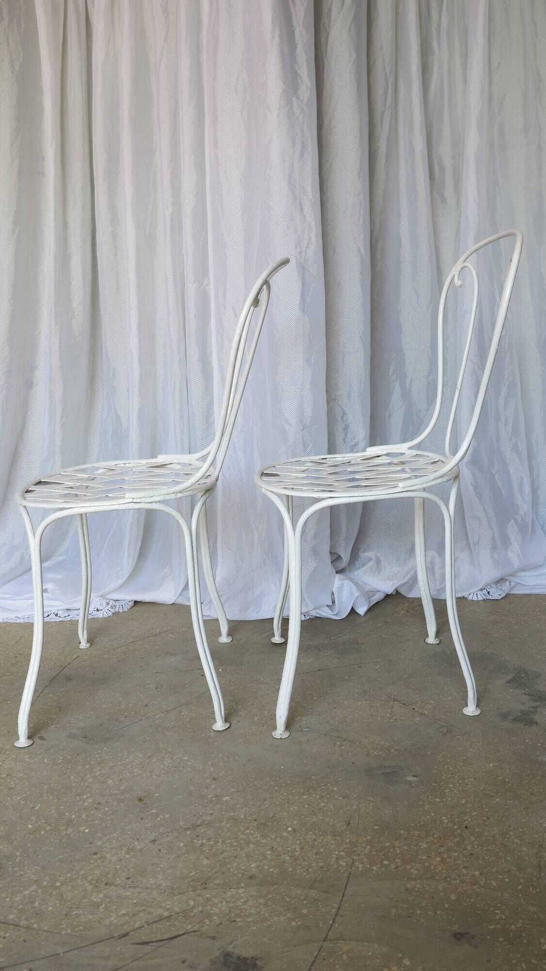 Pair of antique garden chairs, wrought iron, white paint.