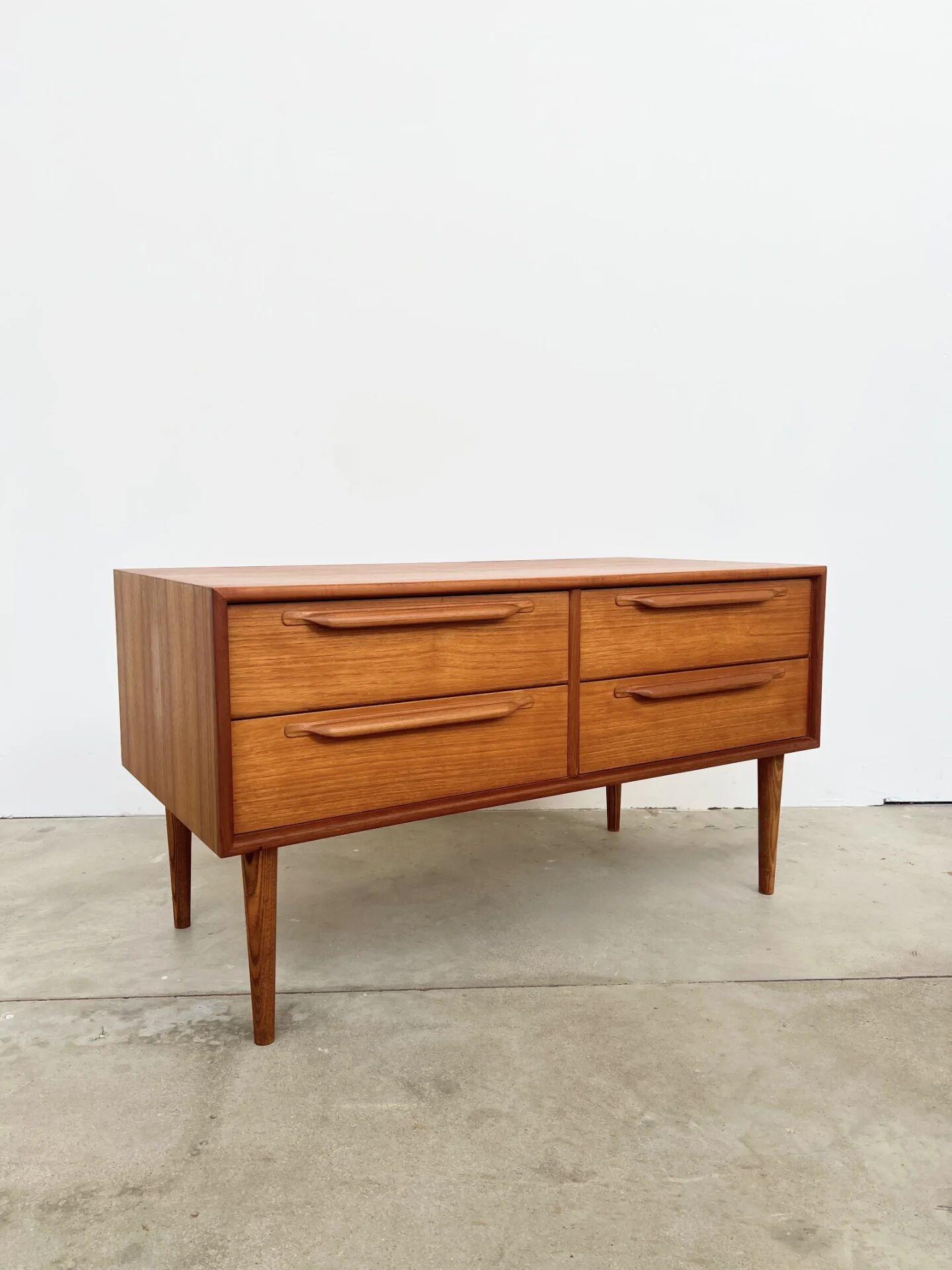 Lowboard teak 4 drawers — Mid-century lines, tapered legs, 1960s