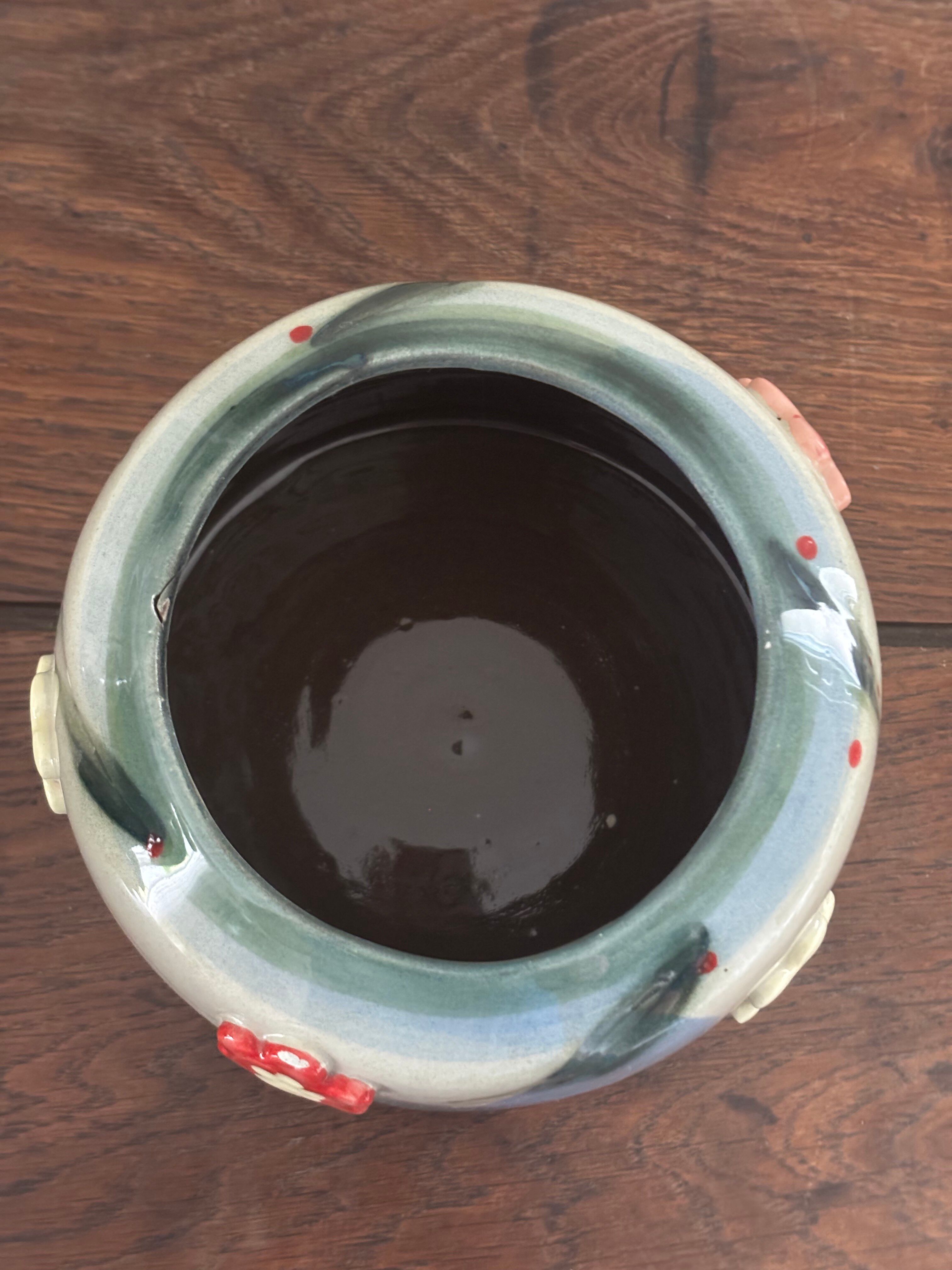 Superb handcrafted pottery pot with relief flowers signed on the back.