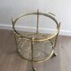 Round brass rolling table attributed to Maison Jansen