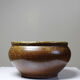 Vintage glazed stoneware bowl or planter in rustic wabi-sabi style.